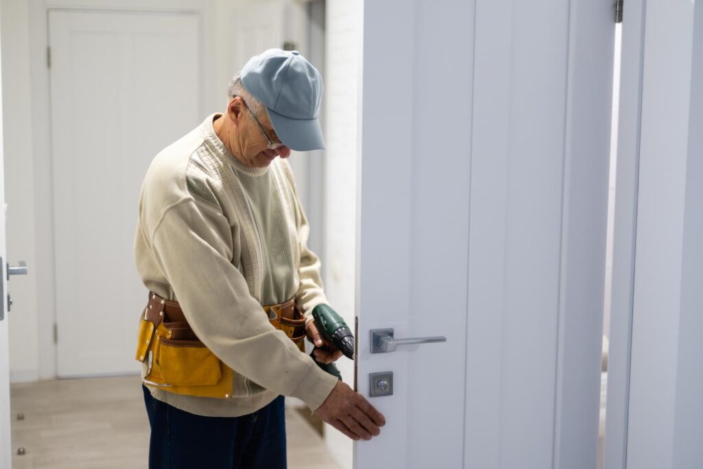 tradesman fixing a door
